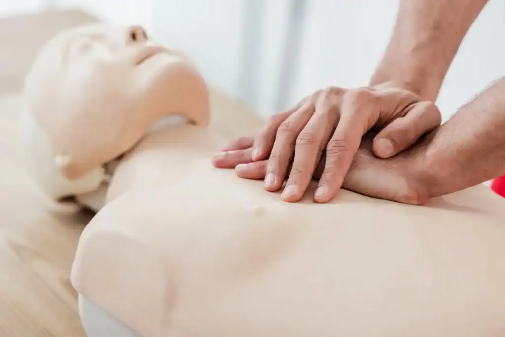 Performing CPR on training mannequin